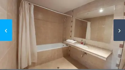 a bathroom with a tub and a sink and a mirror at Terra Complex SPA apartment 1 bedroom suite in Razlog