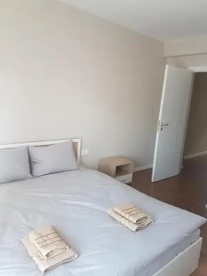 a bedroom with a white bed with two towels on it at LUXURY SUITE 2 in Karlovo