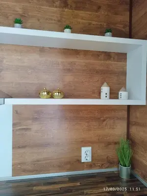 a wooden wall with white shelves in a room at LUXURY SUITE 2 in Karlovo