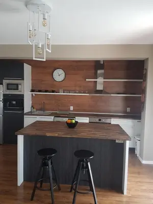 a kitchen with a counter and two bar stools at LUXURY SUITE 2 in Karlovo