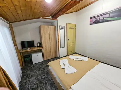 a small room with a bed with towels on it at Guest Rooms- KLEPALSKI House in Borovets