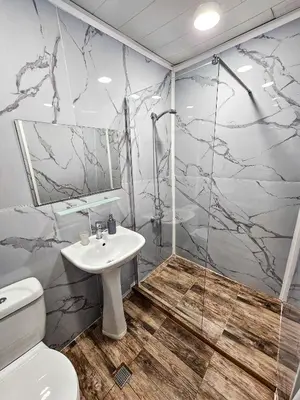 a bathroom with a shower and a toilet and a sink at Guest Rooms- KLEPALSKI House in Borovets