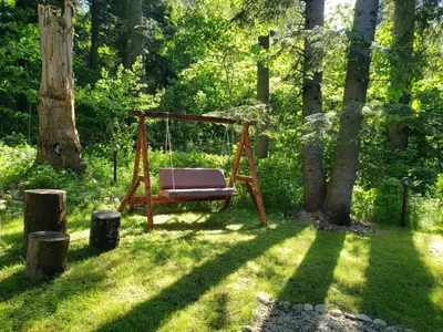 a swing in the grass in a garden at Guest Rooms- KLEPALSKI House in Borovets