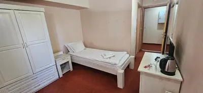 a small room with a bed and a table at Guest House ANEX in Bansko