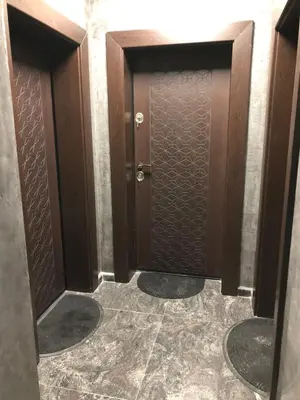 a bathroom with two wooden doors in a room at При Павката (Pri Pavkata) in Samokov