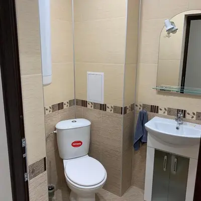 a small bathroom with a toilet and a sink at При Павката (Pri Pavkata) in Samokov