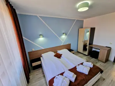 a bedroom with a bed with towels on it at Sapareva Apartments in Sapareva Banya