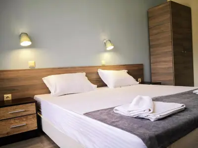 a bedroom with a bed with white towels on it at Sapareva Apartments in Sapareva Banya