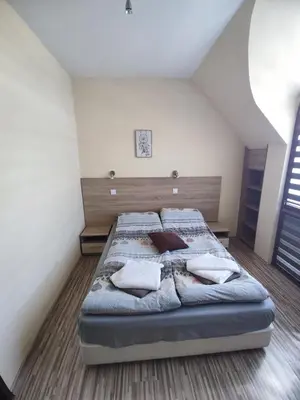 a bedroom with a bed with pillows on it at Sapareva Apartments in Sapareva Banya