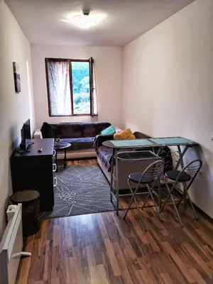 a living room with a table and a couch at Double Studio near SKI Lift - Bansko in Bansko