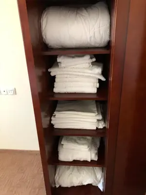 a closet filled with white towels and pillows at Mountain View Apartment in Bansko
