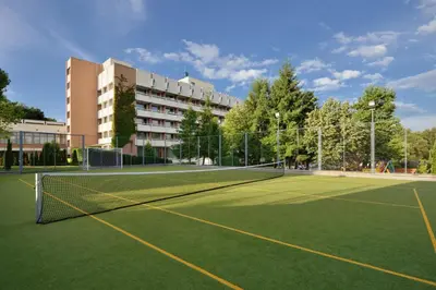 a tennis court in front of a building at Sana Spa Hotel in Hisarya