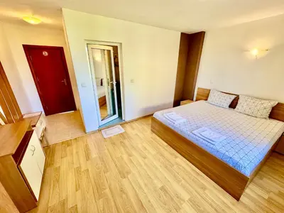 a small room with a bed and a mirror at TM HOUSE - Private Rooms in Bansko