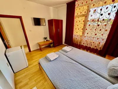 a bedroom with a bed with two towels on it at TM HOUSE - Private Rooms in Bansko
