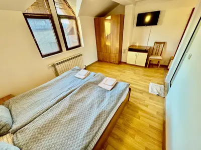 a bedroom with a bed with two towels on it at TM HOUSE - Private Rooms in Bansko
