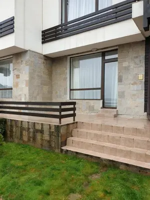 a building with a bench on the side of it at Private Studio in Aspen Golf and Ski Resort in Razlog