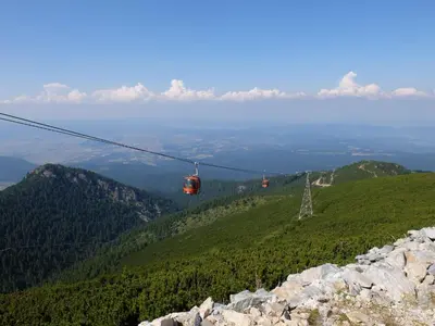 two gondolas on a cable car on a mountain at Borovets Apartments, Iglika 2 in Borovets