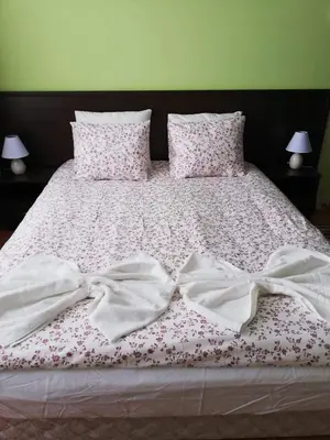 a bed with two white sheets with bows on it at Borovets Apartments, Iglika 2 in Borovets