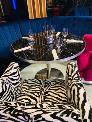 a table with wine glasses and a zebra chair at апартамент Мишел (Mishel) in Samokov