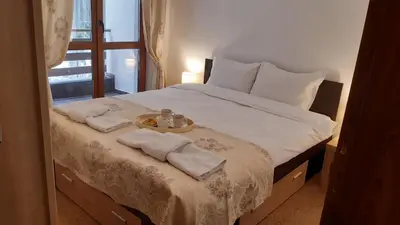 a bedroom with a bed with towels on it at Апартамент Winter home Iceberg in Pamporovo