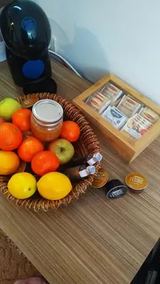 a basket of fruit on a table next to a box at Elitsa Apartment in Pamporovo
