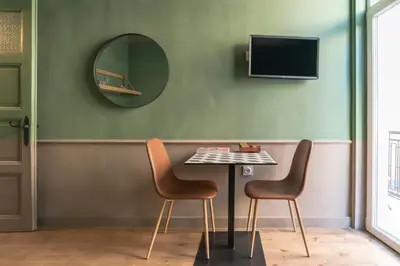 a table with two chairs and a mirror at Beautiful best location apartment Green Mouse in Plovdiv