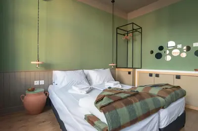 a bedroom with a bed and a green wall at Beautiful best location apartment Green Mouse in Plovdiv