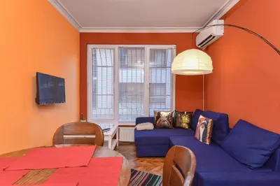 a living room with a blue couch and a table at Vintage Spot - Colorful One-Bedroom Apartment by Flat Mаnager in Sofia