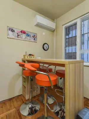 a kitchen with a bar with orange stools at Vintage Spot - Colorful One-Bedroom Apartment by Flat Mаnager in Sofia