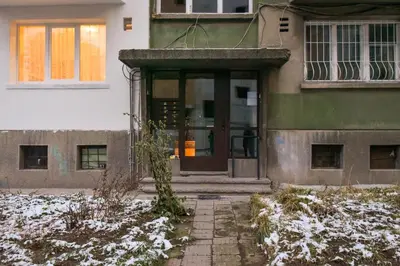 a building with a front door in the snow at Vintage Spot - Colorful One-Bedroom Apartment by Flat Mаnager in Sofia