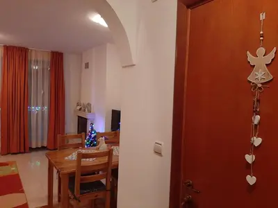 a kitchen and dining room with a table and a christmas tree at Апартамент КАРЛИН in Pamporovo