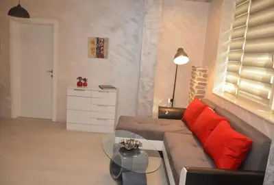 a living room with a couch and a glass table at Apartment Unique in Plovdiv