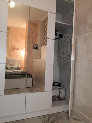 a room with a bed and a glass wall at Apartment Unique in Plovdiv