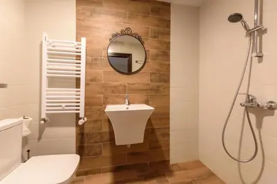a bathroom with a toilet and a sink and a mirror at Villa Ivan & Petar in Semkovo
