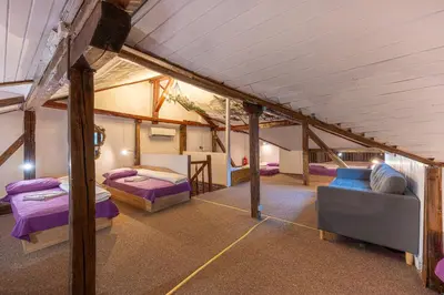 a room with two beds and a couch in a room at Central House for up to 16 Guests Entire Place in Sofia