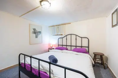 a bedroom with a large bed with purple pillows at Central House for up to 16 Guests Entire Place in Sofia