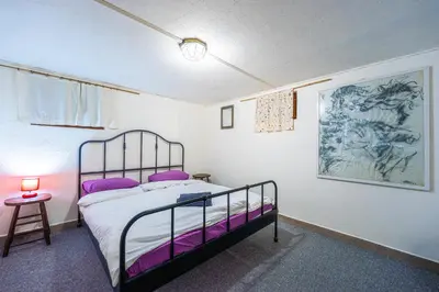 a bedroom with a bed with purple pillows at Central House for up to 16 Guests Entire Place in Sofia