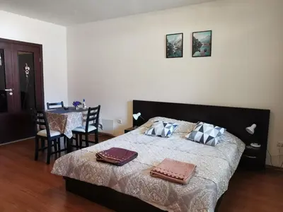 a bedroom with a bed with two towels on it at Sunny studio apartment - few steps from Gondola in Bansko
