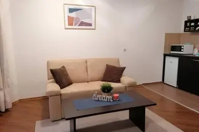 a living room with a couch and a coffee table at Sunny studio apartment - few steps from Gondola in Bansko