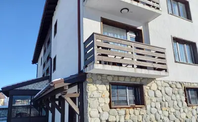 a building with a balcony on the side of it at Къща за гости 