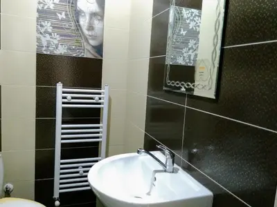 a bathroom with a sink and a mirror at Къща за гости 