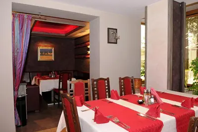a dining room with a table with red napkins at Hotel Balkan in Botevgrad