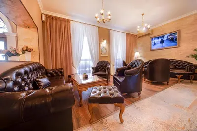 a living room with leather furniture and a couch at Hotel Antique - free private parking in Plovdiv