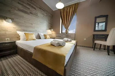 a hotel room with a bed with towels on it at Hotel Antique - free private parking in Plovdiv