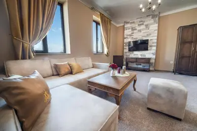 a living room with a couch and a table at Hotel Antique - free private parking in Plovdiv