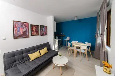a living room with a couch and a table at Rebus Apartments in Sandanski