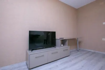 a flat screen tv sitting on top of a entertainment center at ГеВе Апартаменти in Sandanski