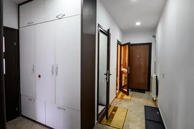 a bathroom with white cabinets and a walk in closet at Апартамент за гости Римски терми in Kyustendil