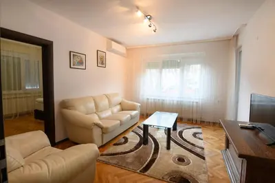 a living room with a couch and a table at Апартамент за гости Римски терми in Kyustendil