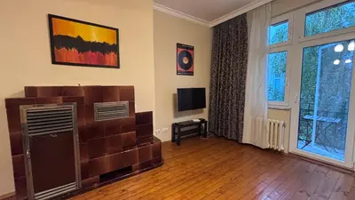 a living room with a television and a large window at 66 in Sofia in Sofia